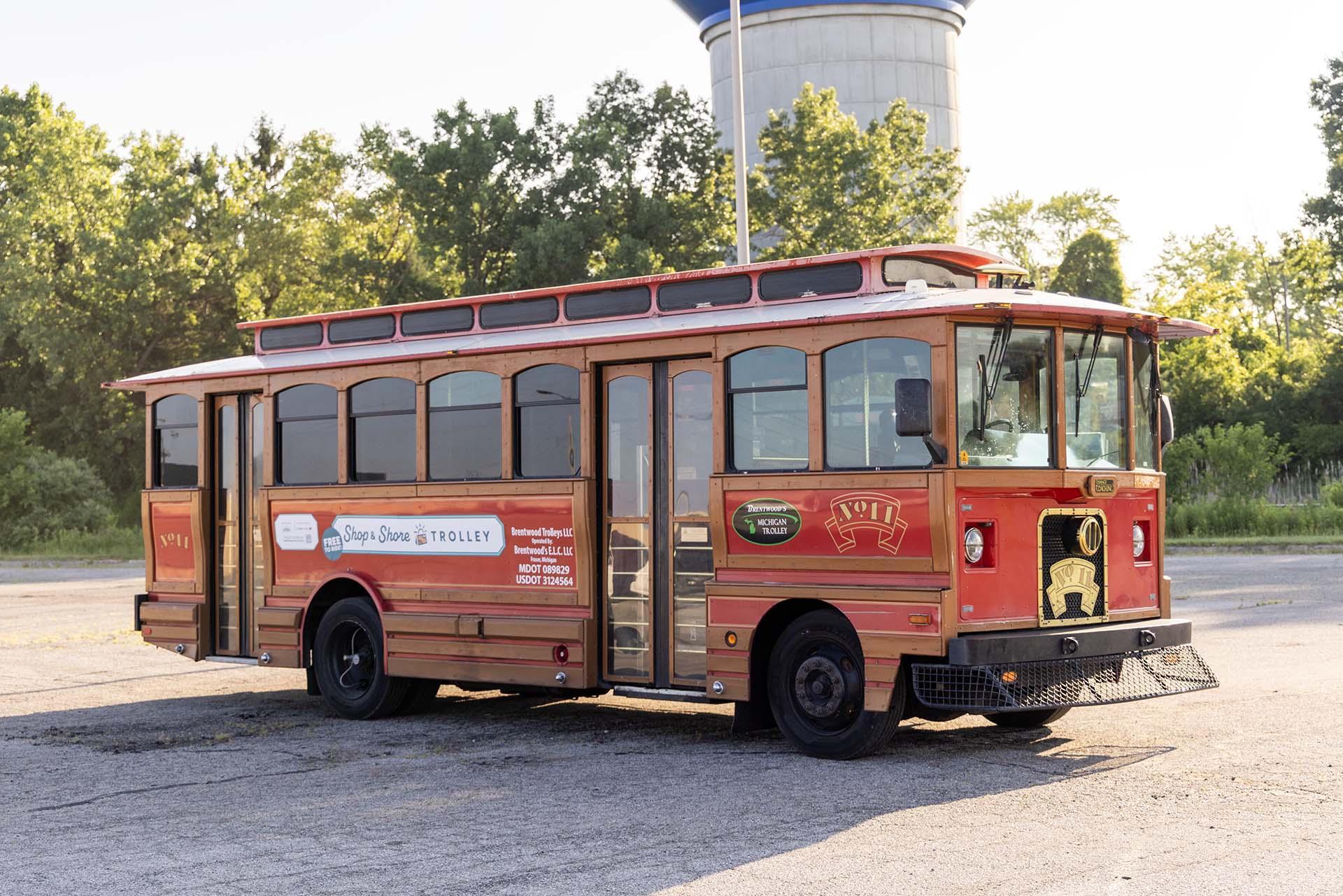 A family getting off of the Shop & Shore Trolley.