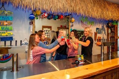 Staff cheers group photo at the back bar