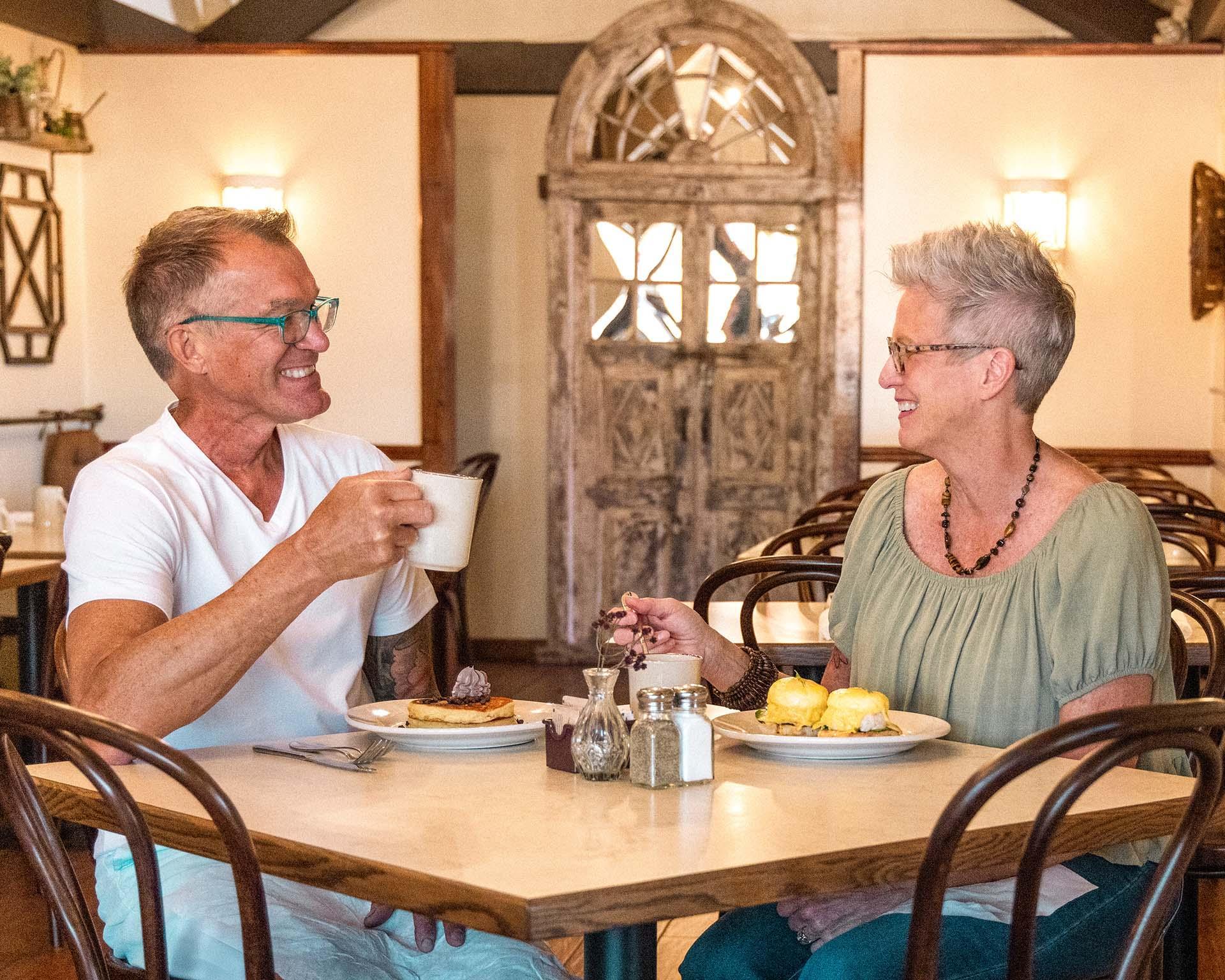 Two people enjoying breakfast at Copper Pot.