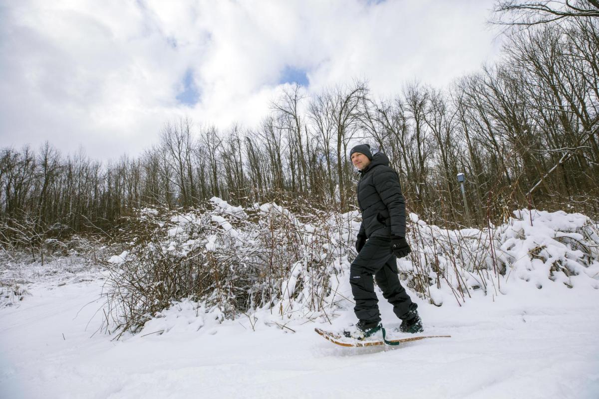A man snowshoeing at Love Creek.