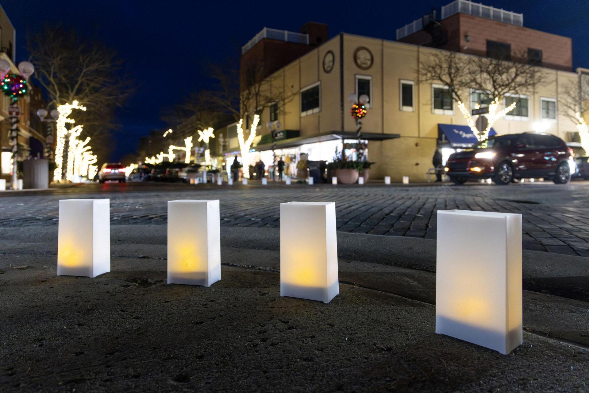 Glowing luminaries line the streets of downtown St. Joseph at night.