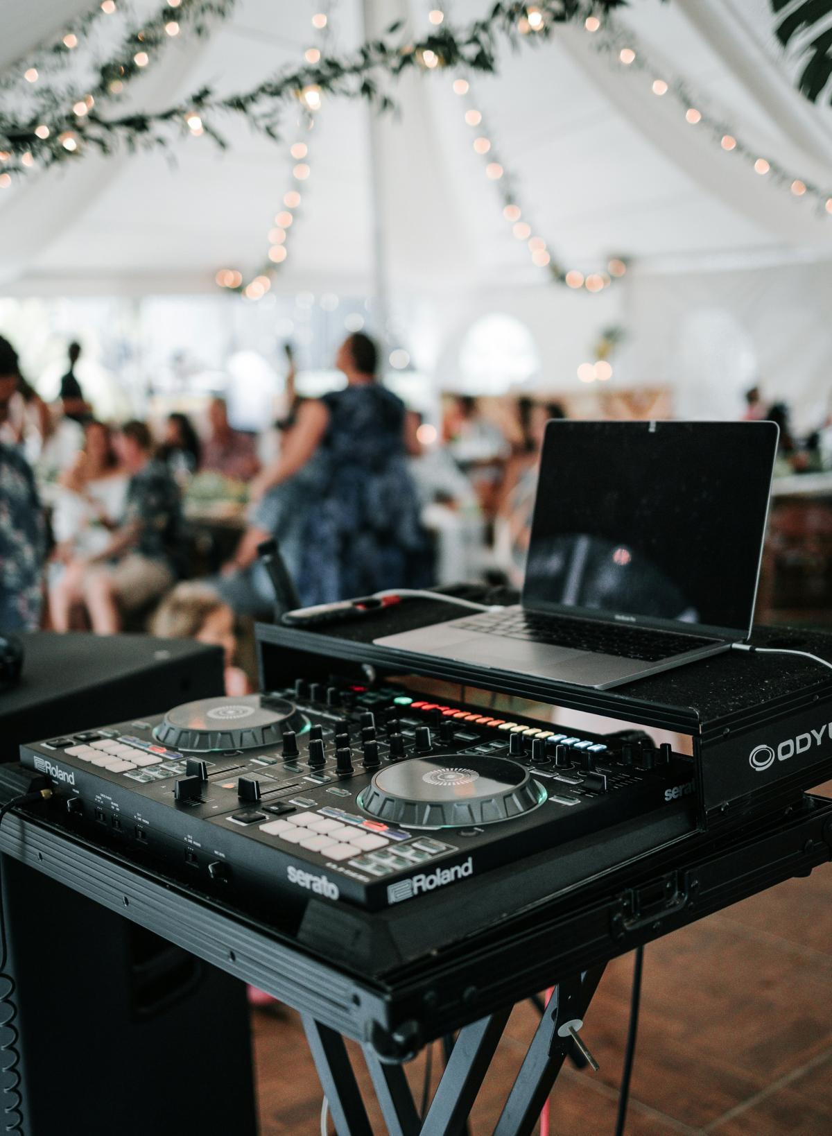 A DJ equipment setup prepared for a wedding celebration.
