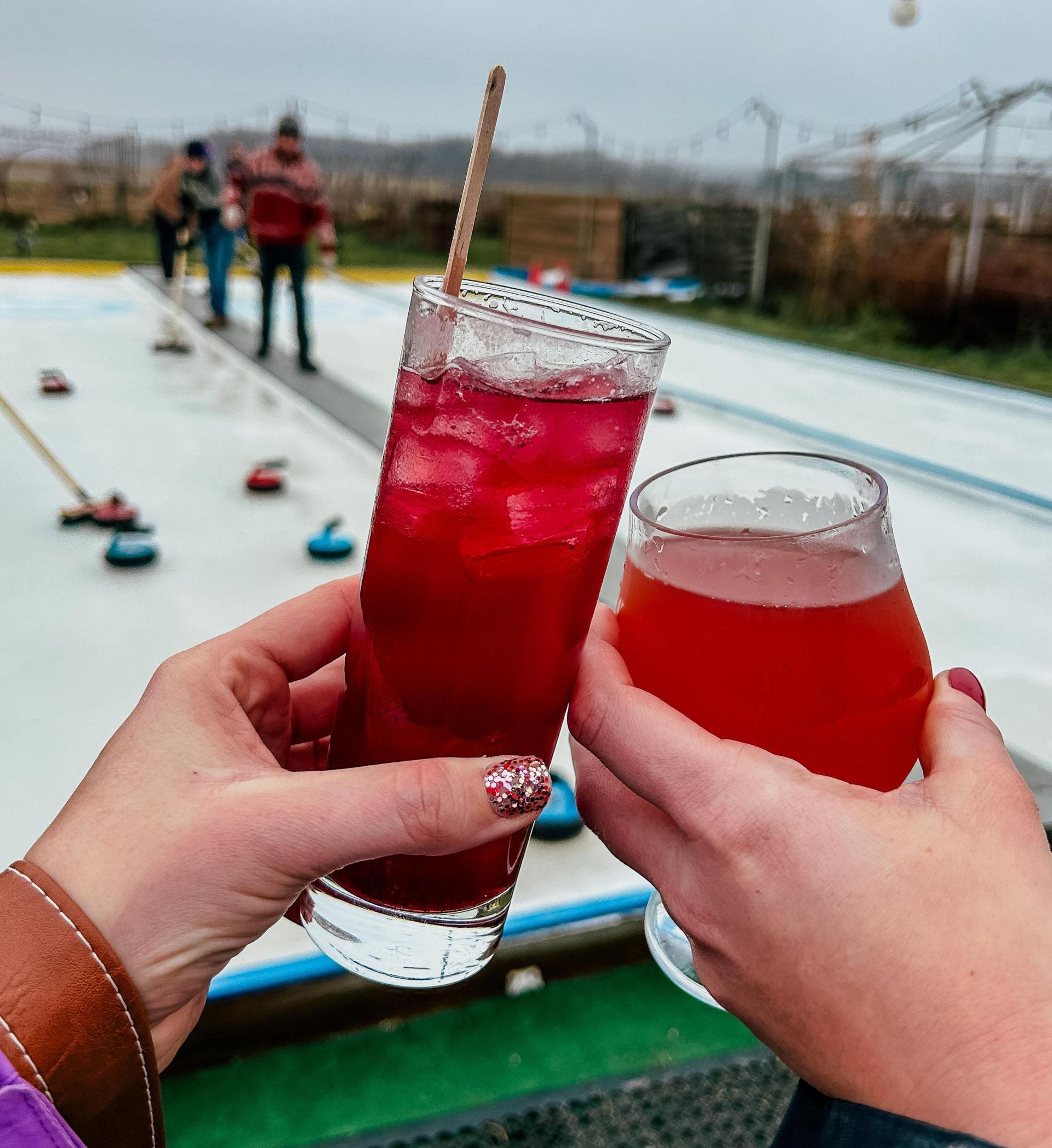 Two people relax with drinks while watching a game of the river rocks at River Saint Joe Brewery.