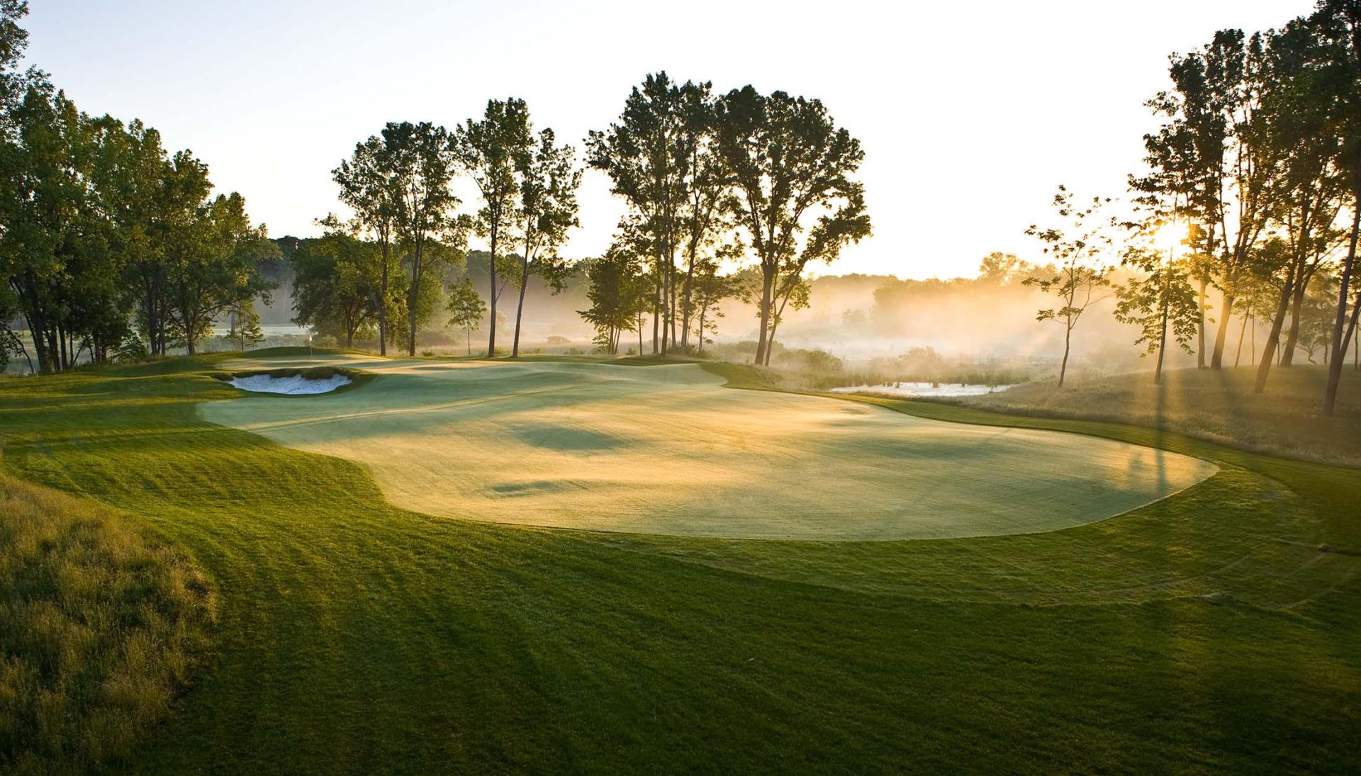 A peaceful morning fog rolls across the fairways at Harbor Shores Golf Course along the Lake Michigan shoreline.