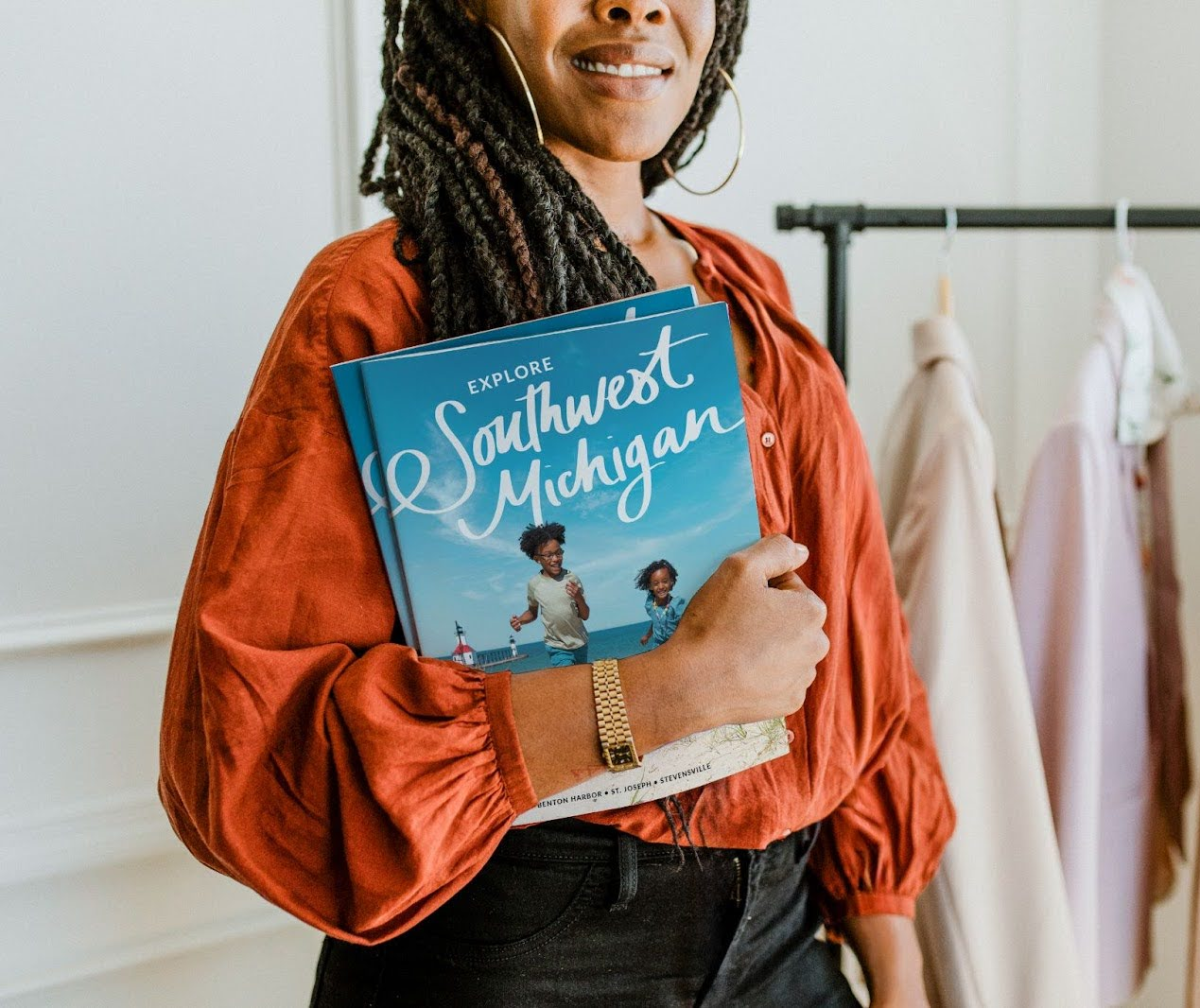 A Woman holding the Visit Southwest Michigan Visitors Guide