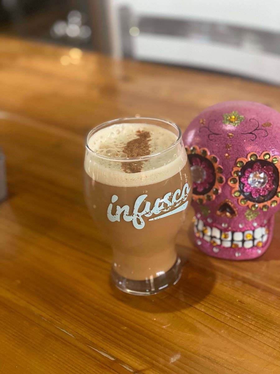 a glass of pumpkin spice cold foam coffee