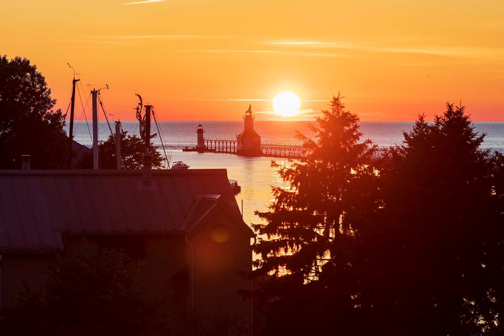 View of the sunset and lighthouses from Lake Bluff Park. 